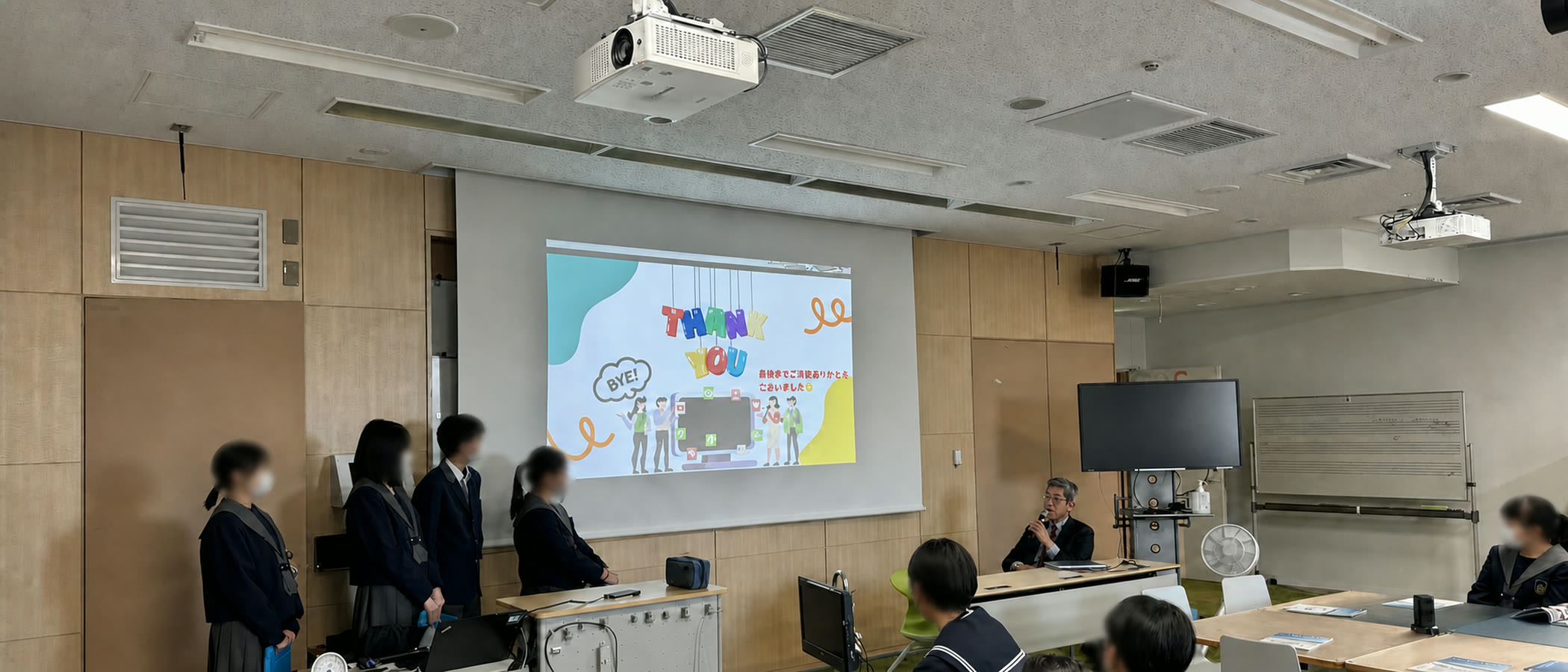 中学生の発表を見守りながら授業に参加する岸博幸